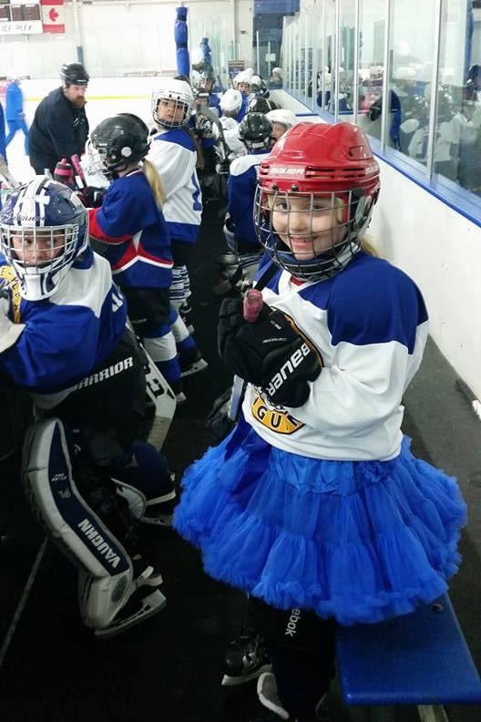 An image of 6 year old London in a tutu playing hockey - Dust Off Rinkwear